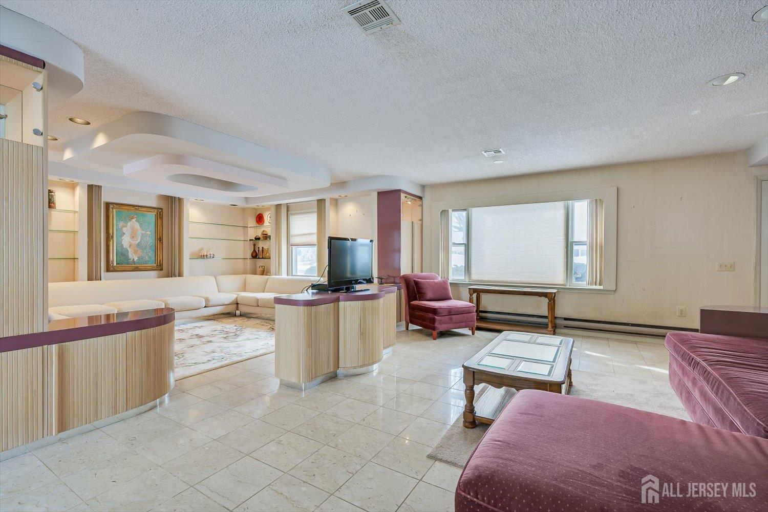 628A Windsor Way, Unit B Monroe Township, NJ 08831 - Photo 11 of 50 a living room with furniture a rug and a window