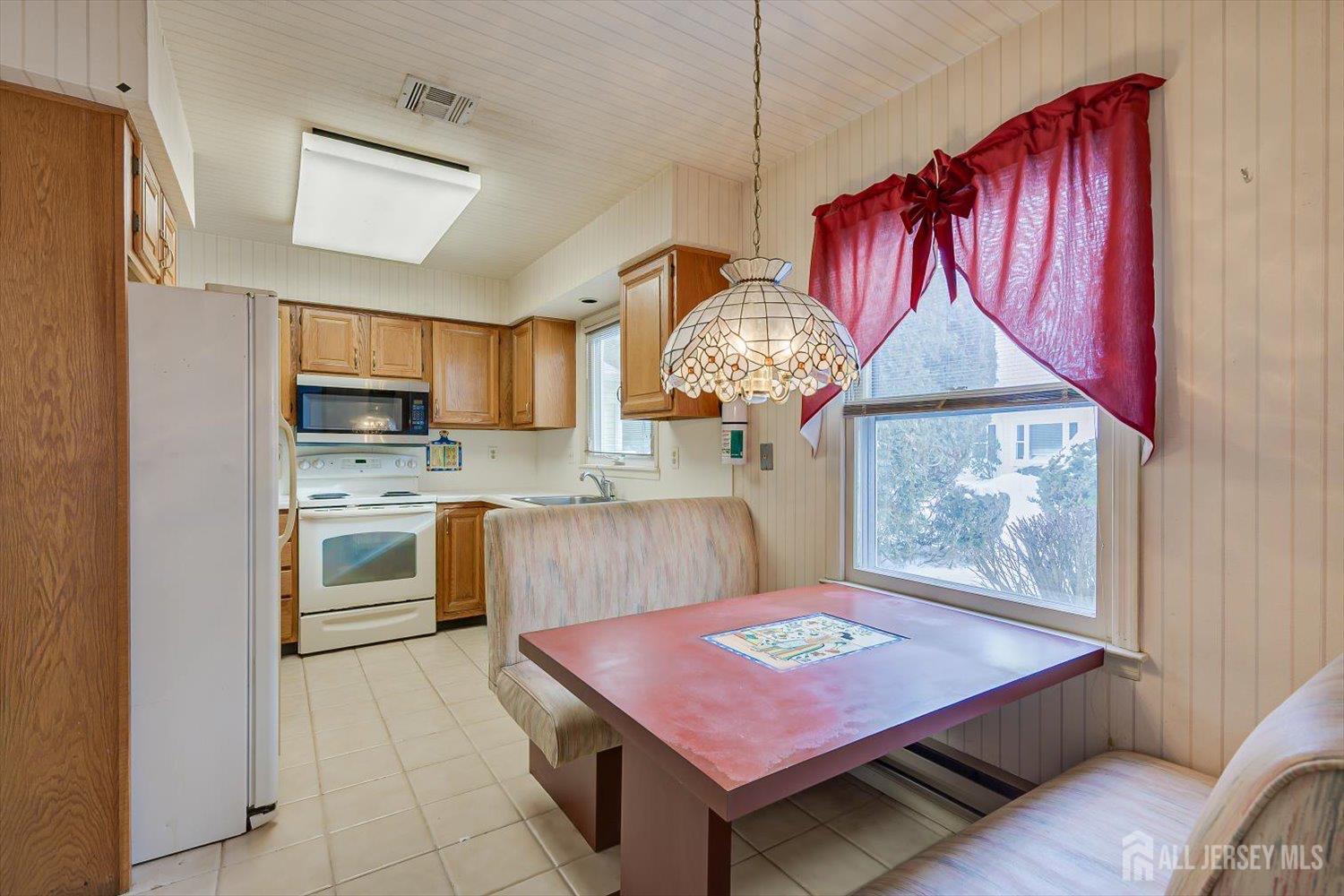 628A Windsor Way, Unit B Monroe Township, NJ 08831 - Photo 16 of 50 a kitchen with a stove a refrigerator and wooden cabinets