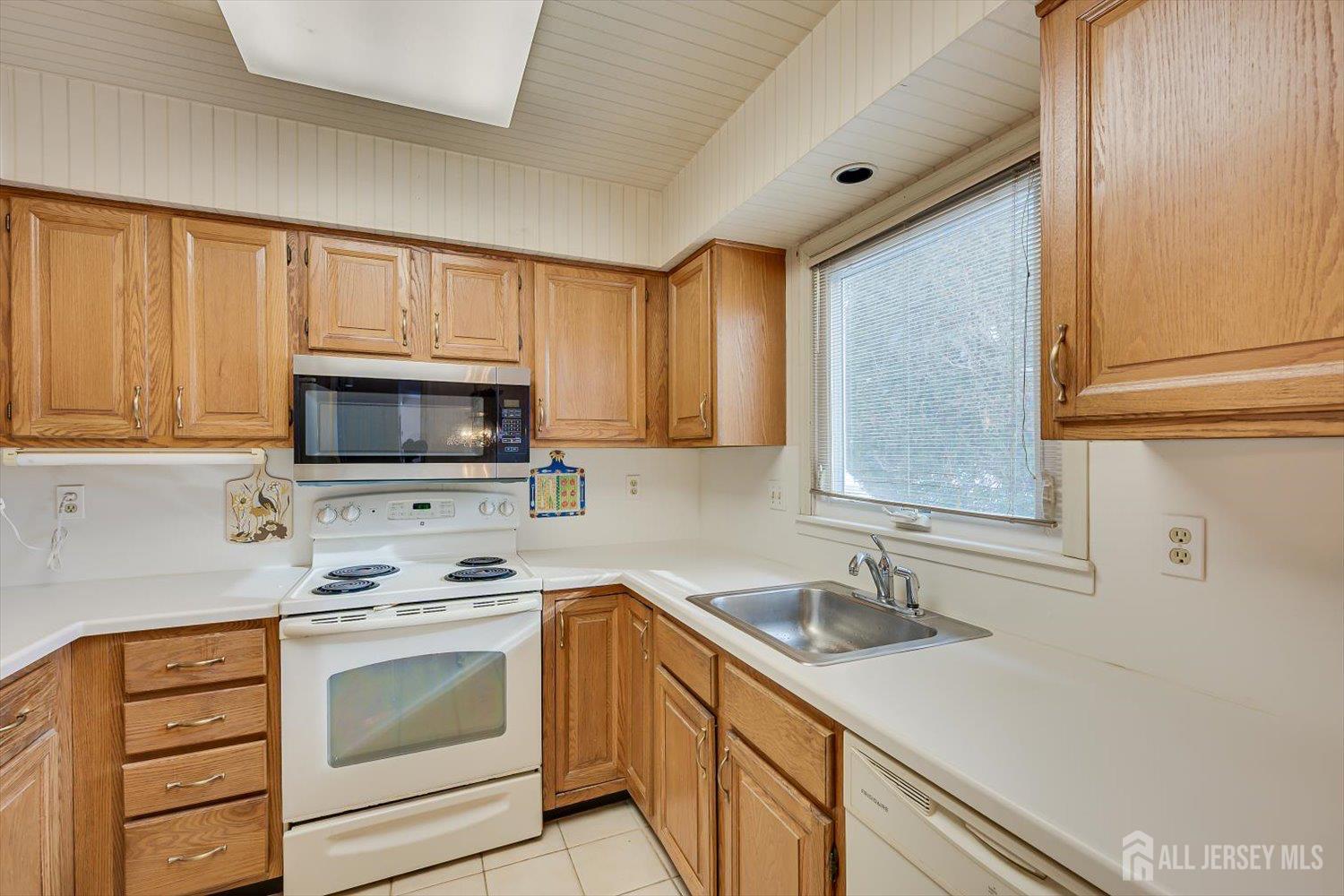 628A Windsor Way, Unit B Monroe Township, NJ 08831 - Photo 17 of 50 a kitchen with stainless steel appliances granite countertop a sink stove and microwave