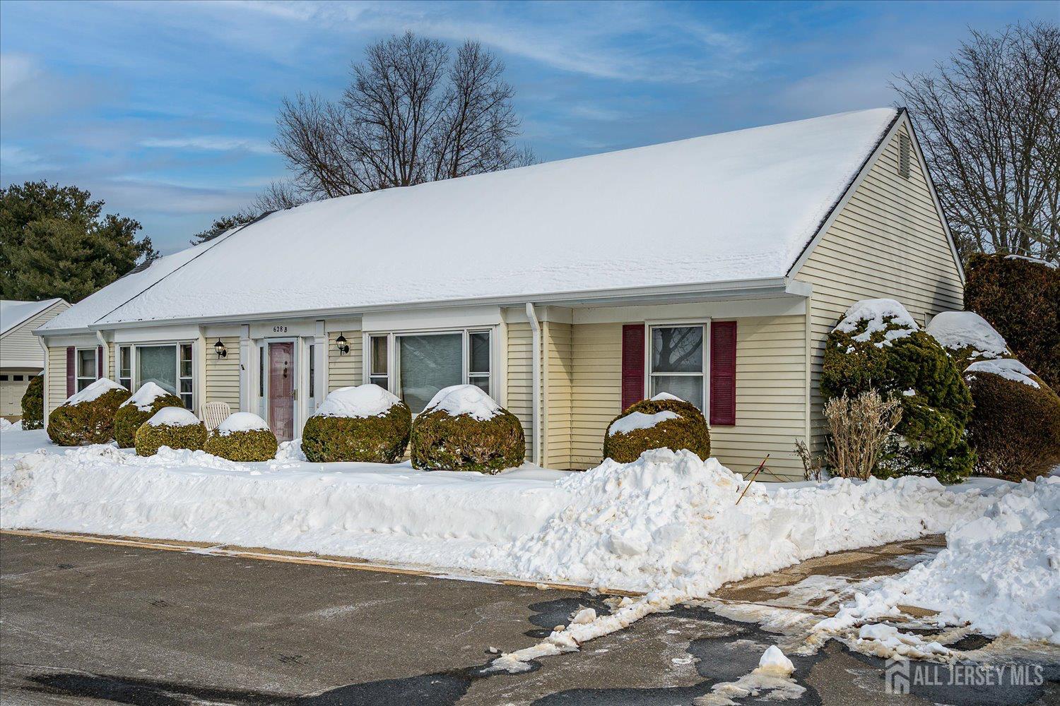 628A Windsor Way, Unit B Monroe Township, NJ 08831 - Photo 3 of 50 a front view of a house with a yard