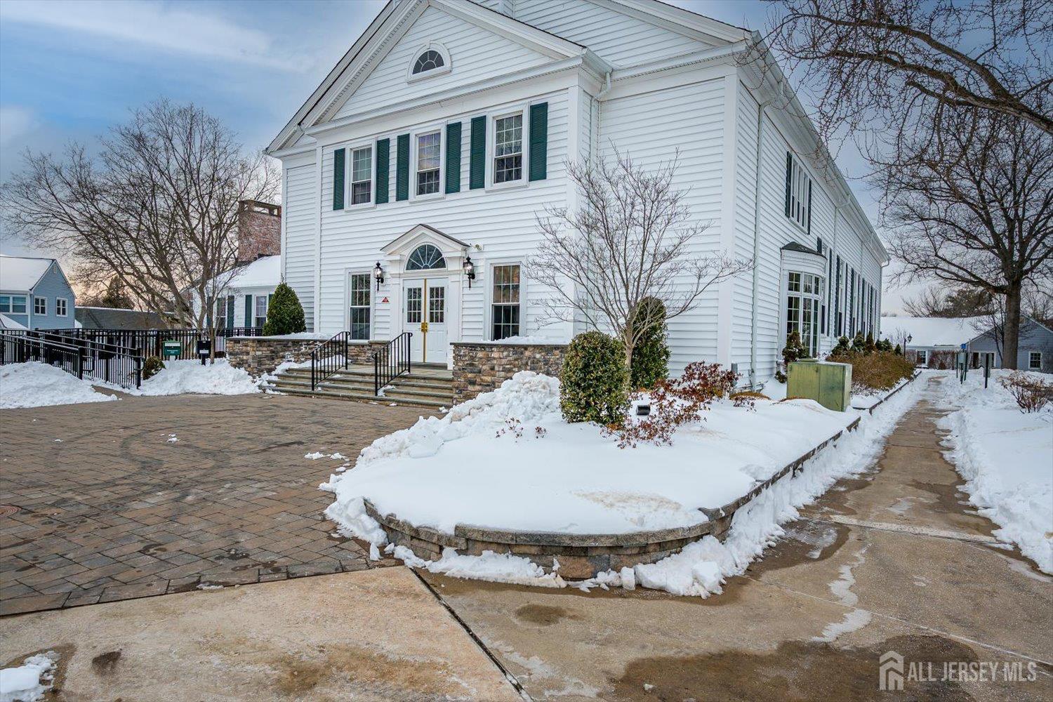 628A Windsor Way, Unit B Monroe Township, NJ 08831 - Photo 49 of 50 a view of a white house with a yard