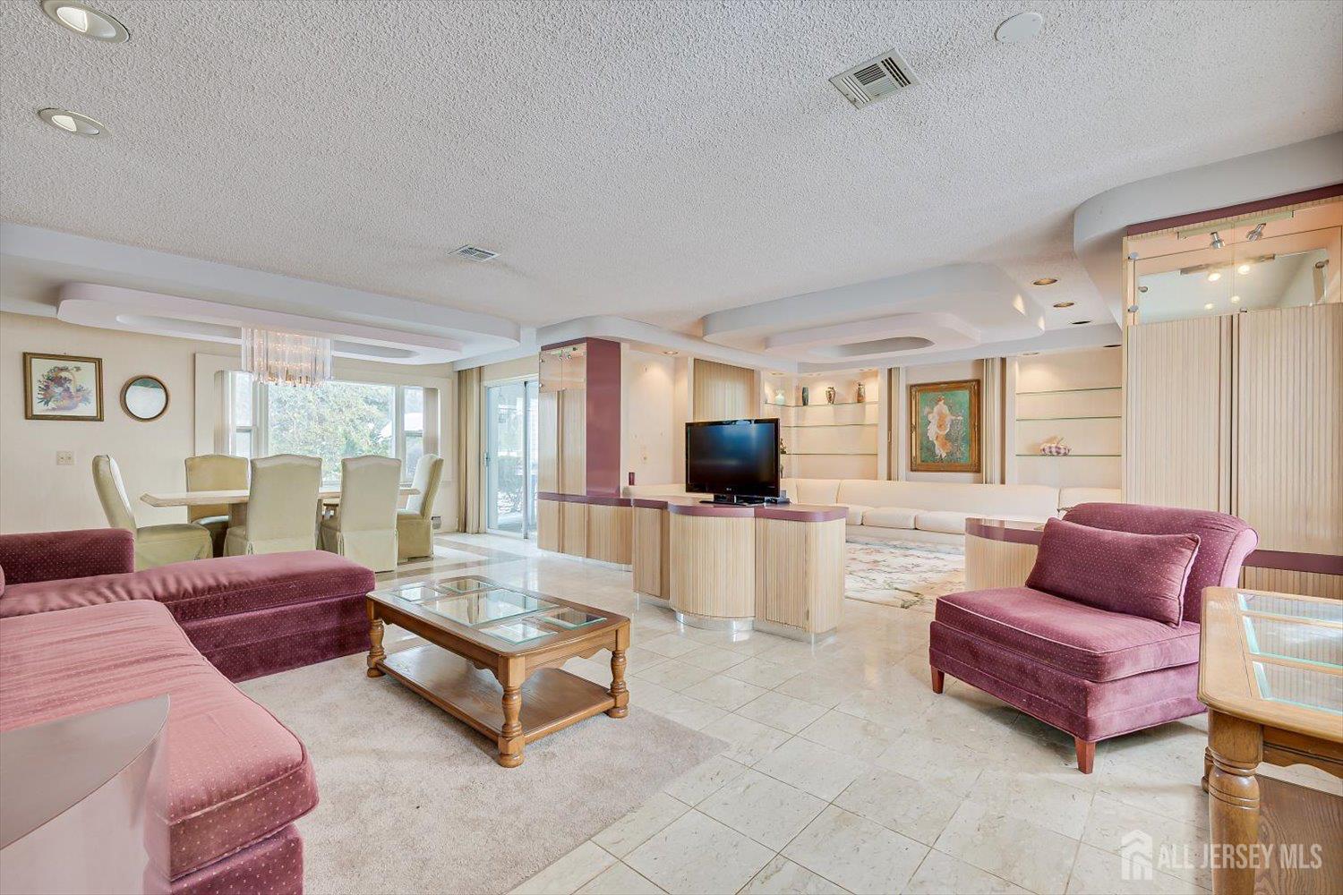 628A Windsor Way, Unit B Monroe Township, NJ 08831 - Photo 9 of 50 a living room with furniture and a flat screen tv