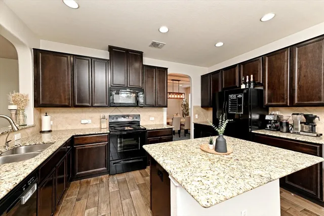 a kitchen with granite countertop stainless steel appliances and sink