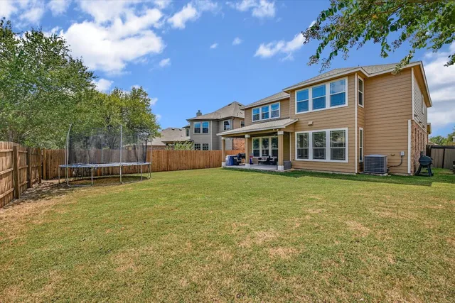 a view of a house with a backyard