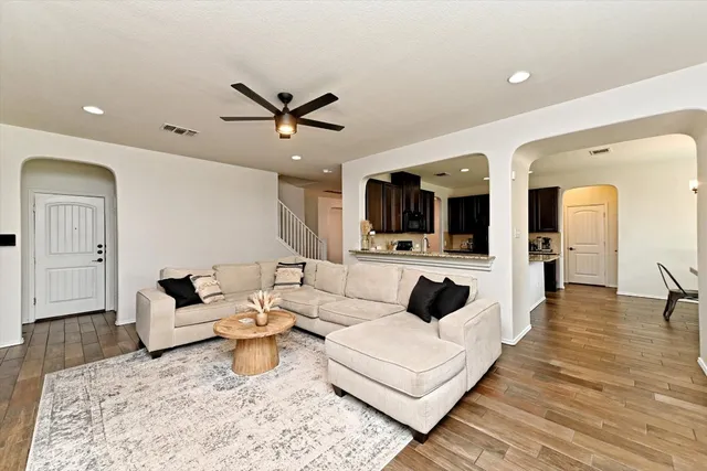 a living room with furniture and wooden floor