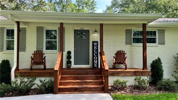 a front view of a house with garden