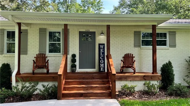 a front view of a house with garden
