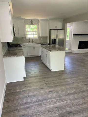a kitchen with a sink stove and refrigerator