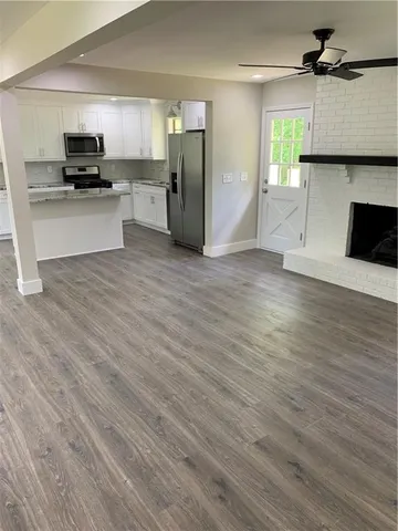a kitchen with a refrigerator and a stove top oven