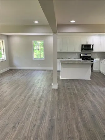a view of kitchen with microwave and window