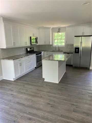 a kitchen with a refrigerator and window