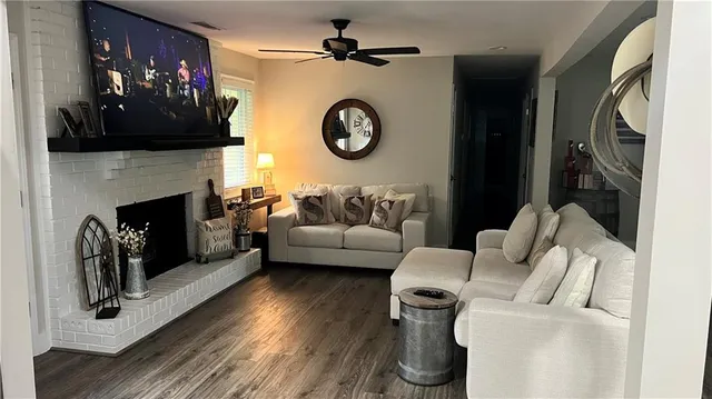 a living room with furniture a fireplace and a flat screen tv