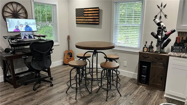 a view of a workspace with furniture and a window