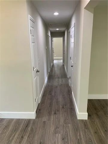 a view of a hallway with wooden floor