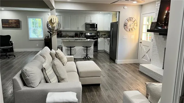 a living room with furniture and a wooden floor