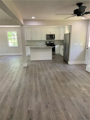 a view of kitchen with microwave and window