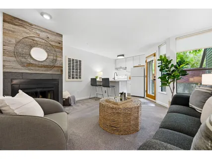 a living room with furniture a fireplace and a potted plant