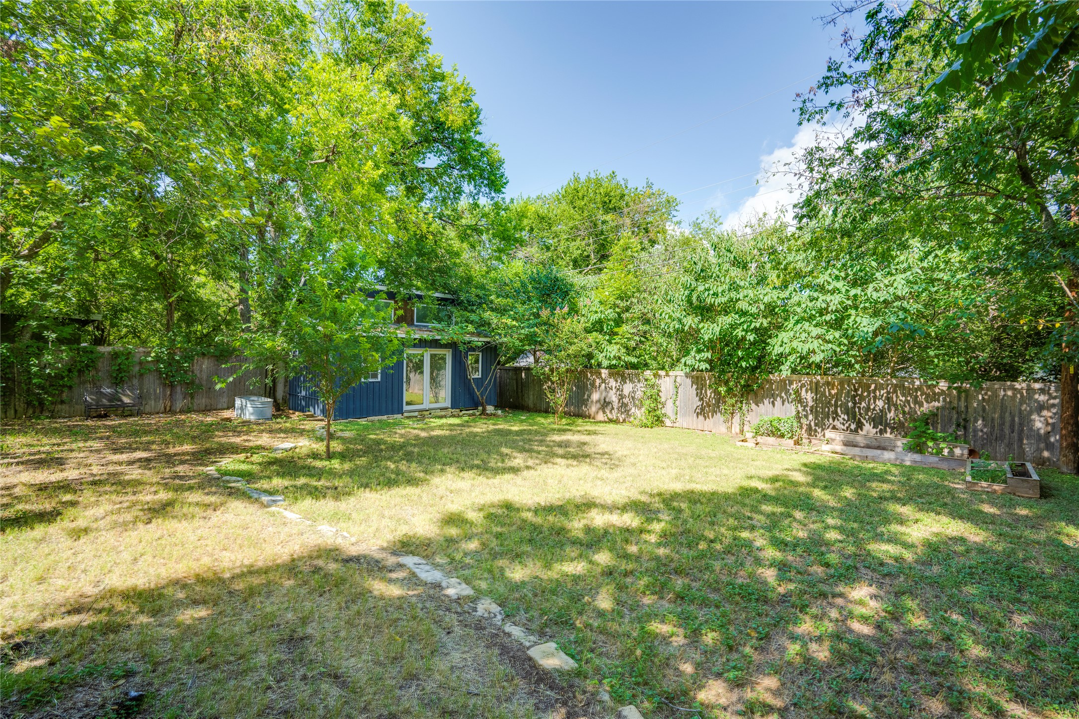 5300 Halmark Drive Austin, TX 78723 - Photo 33 of 40 A spacious, verdant yard with mature trees offers a private, serene outdoor retreat.