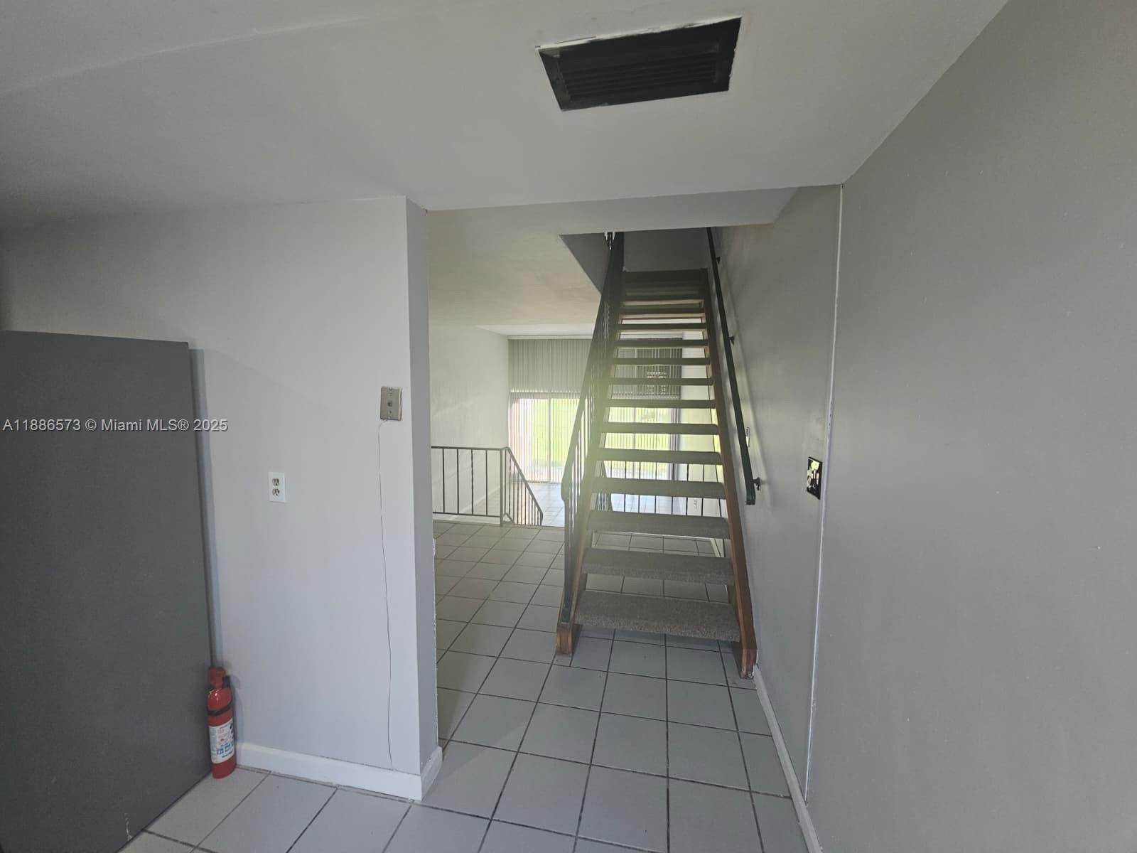 6782 Brookline Drive, Unit 6782 Hialeah, FL 33015 - Photo 14 of 27 a view of empty room with wooden floor and fan