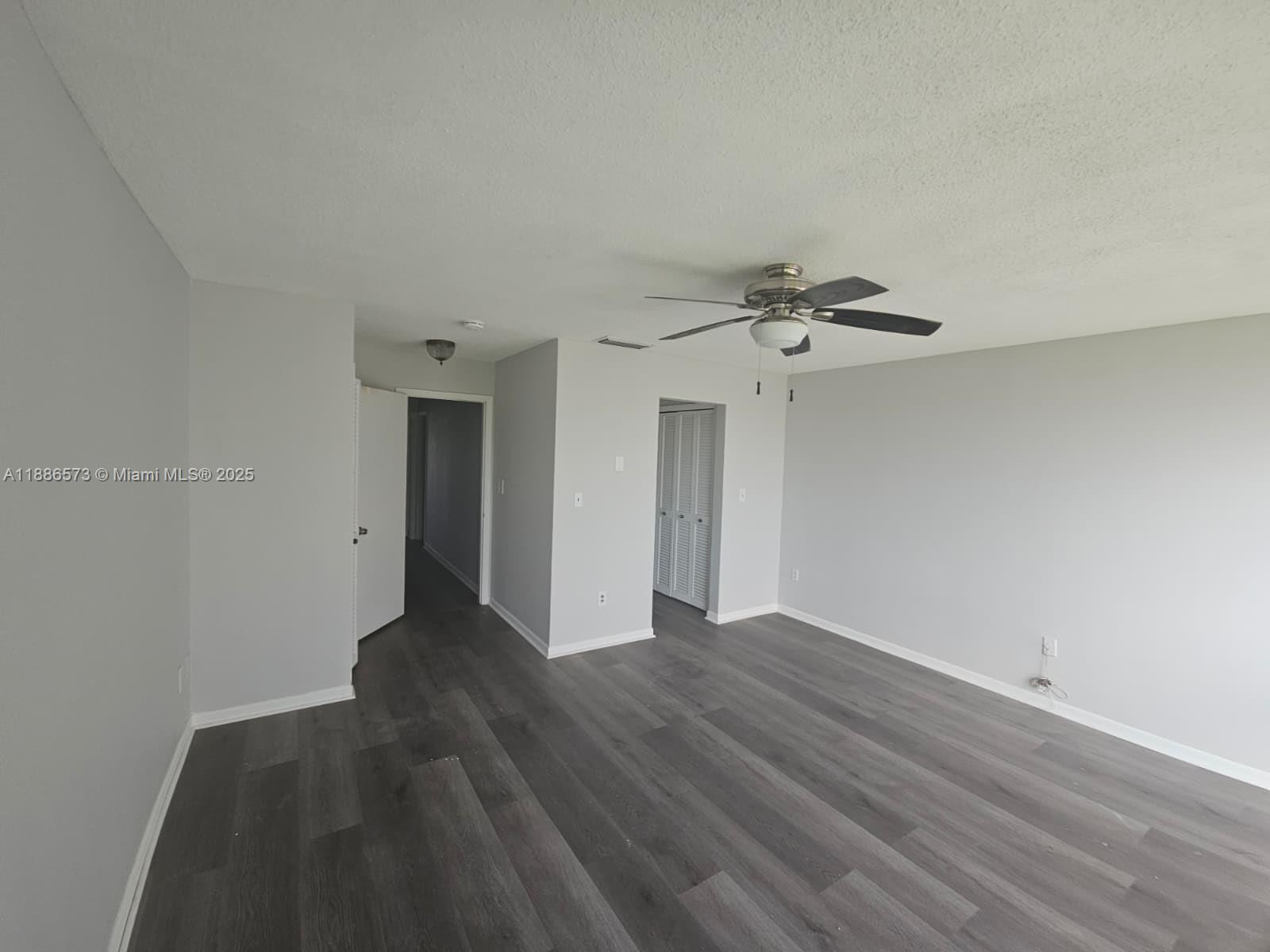 6782 Brookline Drive, Unit 6782 Hialeah, FL 33015 - Photo 18 of 27 a view of a livingroom with wooden floor and a ceiling fan