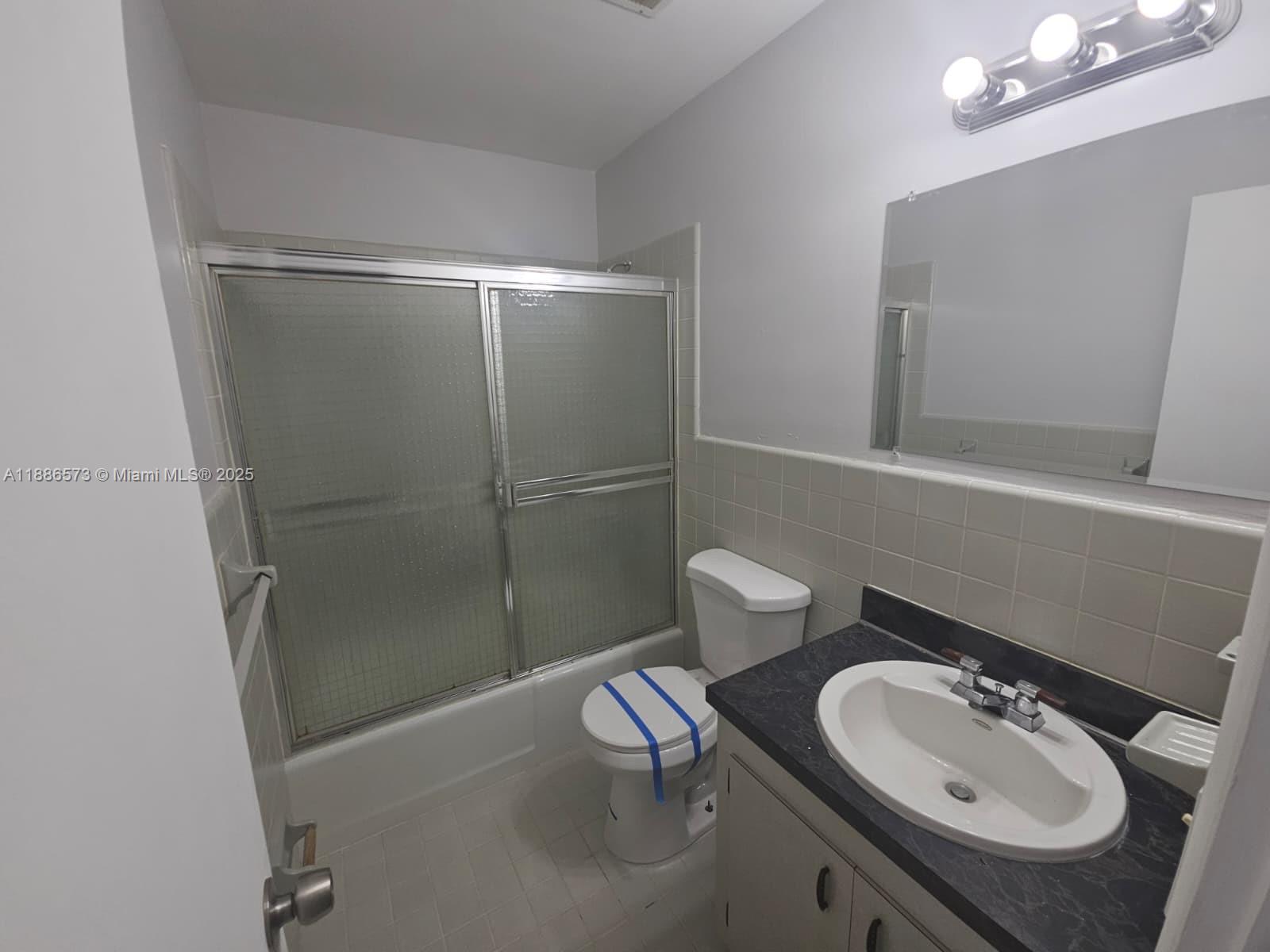 6782 Brookline Drive, Unit 6782 Hialeah, FL 33015 - Photo 20 of 27 a bathroom with a sink toilet and shower