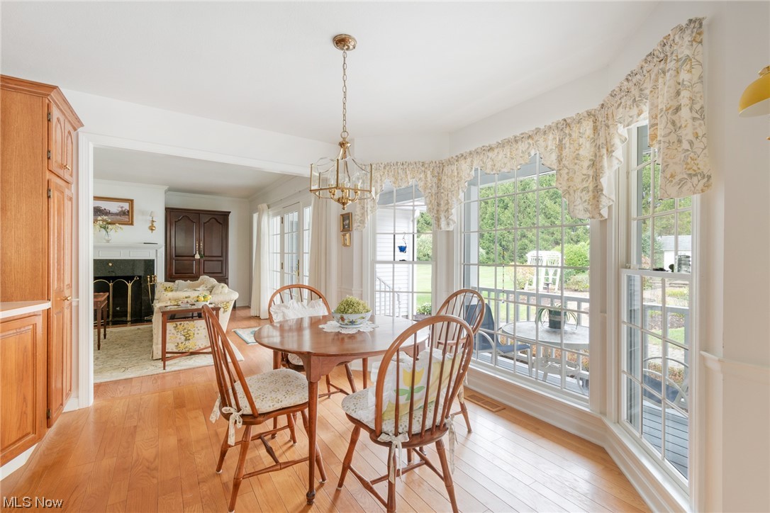 10822 West Calla Road Salem, OH 44460 - Photo 25 of 34 Dining area with light hardwood / wood-style floors and a notable chandelier