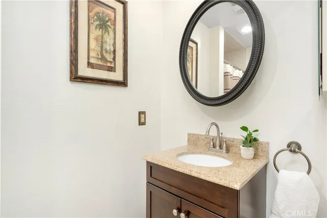 a white toilet sitting next to a bathroom sink