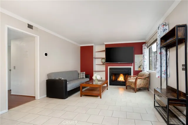 a living room with furniture a fireplace and a flat tv screen