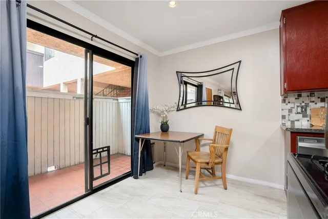 a dining room with furniture and a window