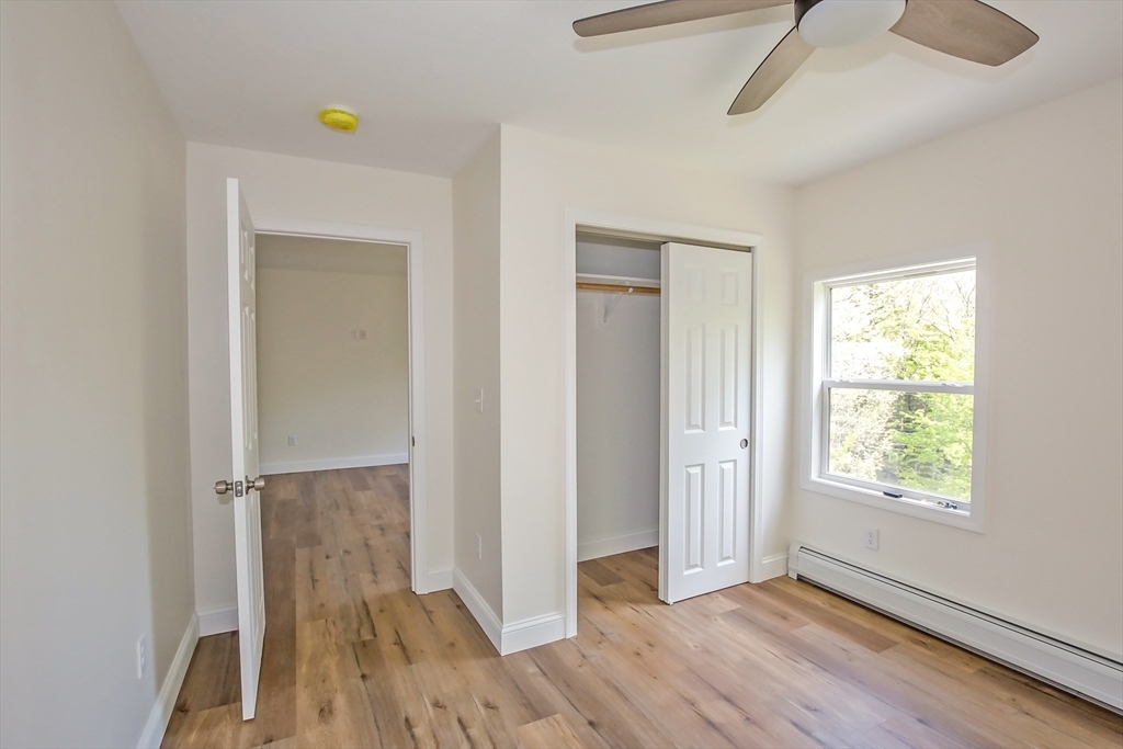 165 Sandisfield Road Sandisfield, MA 01255 - Photo 32 of 37 a view of empty room with wooden floor and fan