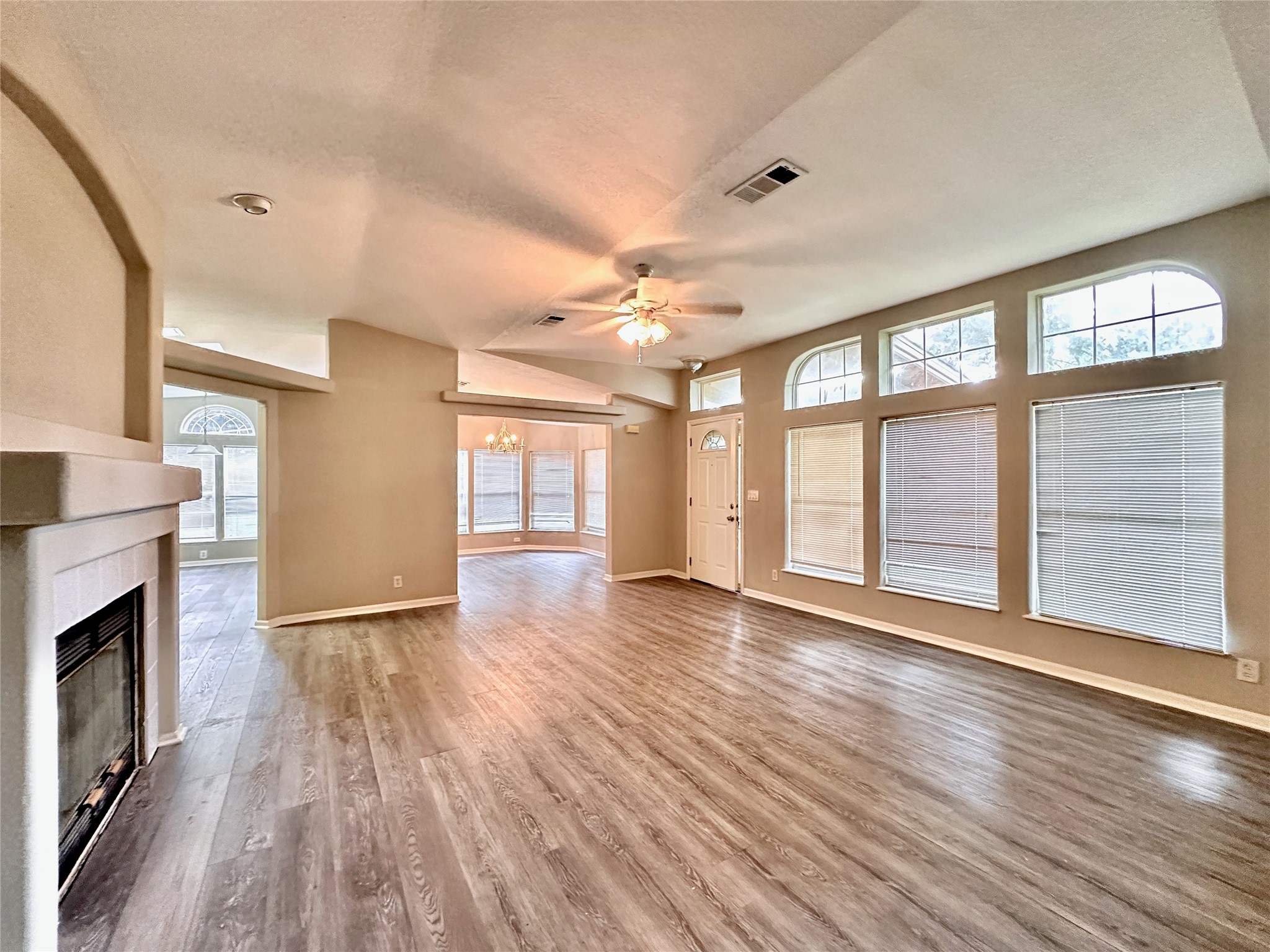 202 Main Street Fresno, TX 77545 - Photo 6 of 26 a view of an empty room with wooden floor and a window