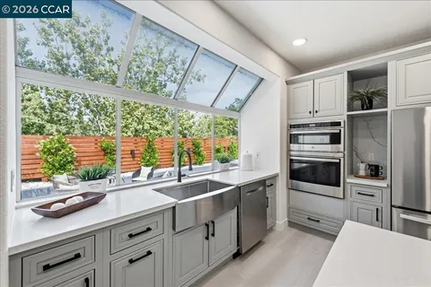 a kitchen with stainless steel appliances a sink stove and refrigerator