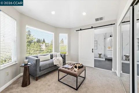 a bedroom with furniture and a large window