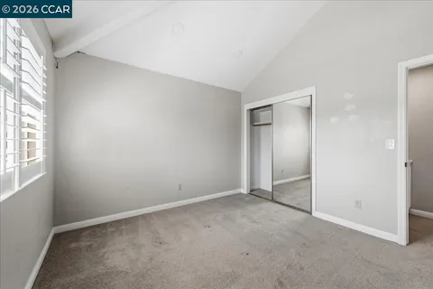 an empty room with windows and closet