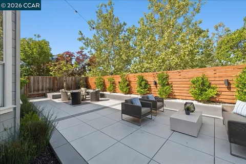a view of roof deck with couches and potted plants
