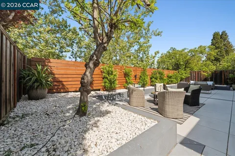 a backyard of a house with table and chairs