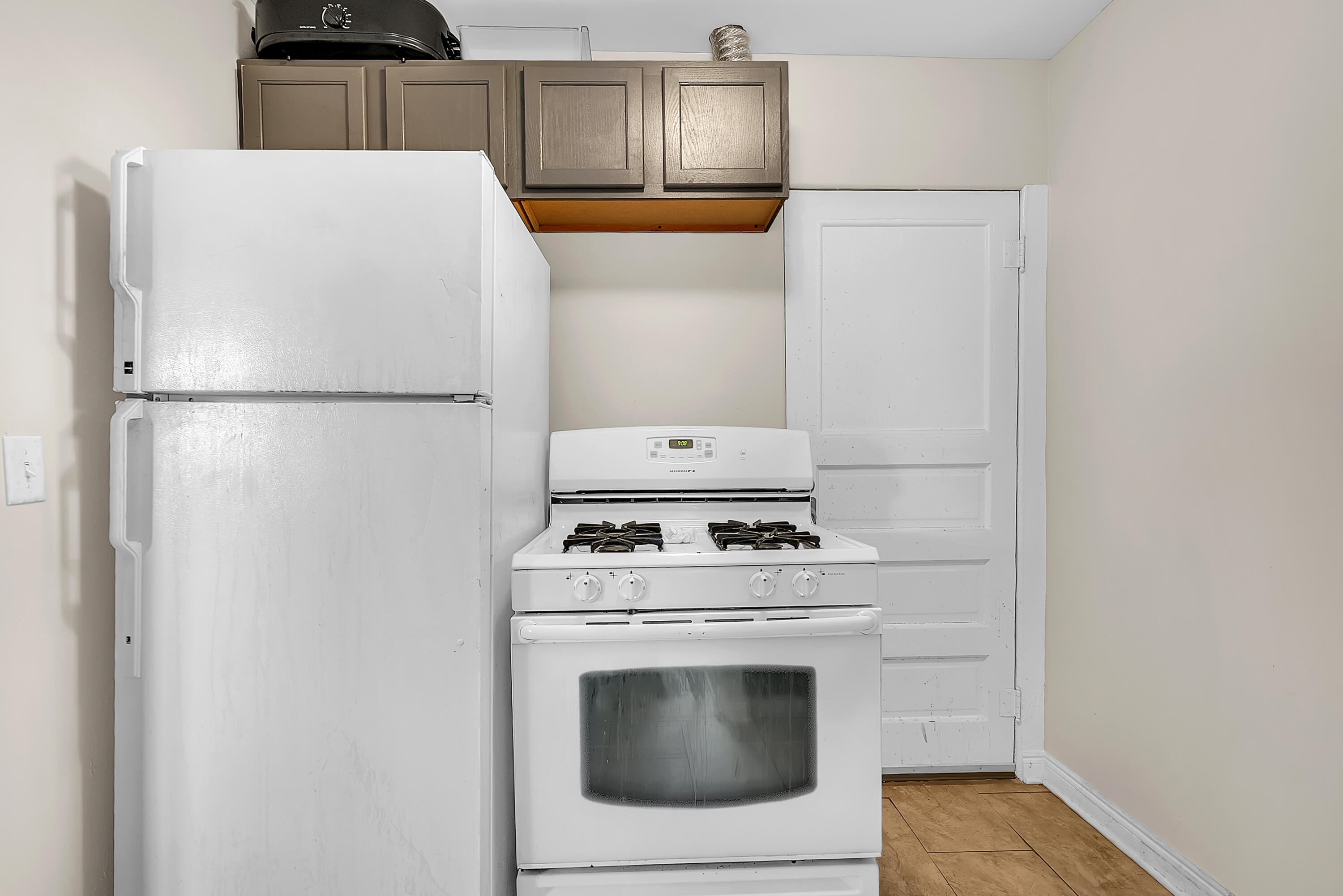 15 Rimbach Street Hammond, IN 46320 - Photo 25 of 31 a white refrigerator freezer and a stove sitting inside of a kitchen