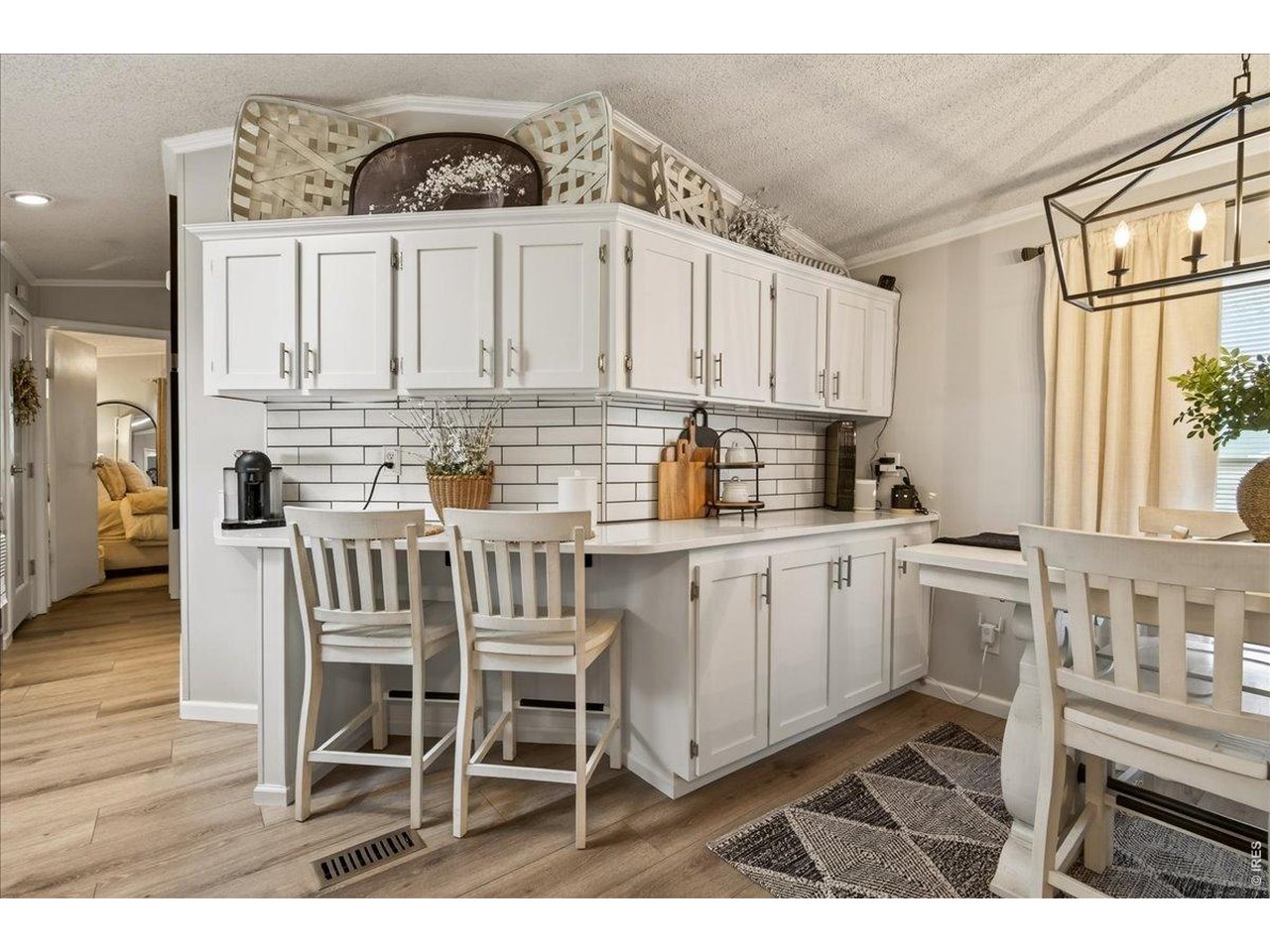 8410 Madison Way Denver, CO 80229 - Photo 6 of 40 Breakfast bar seating offers convenience for casual meals or gatherings.