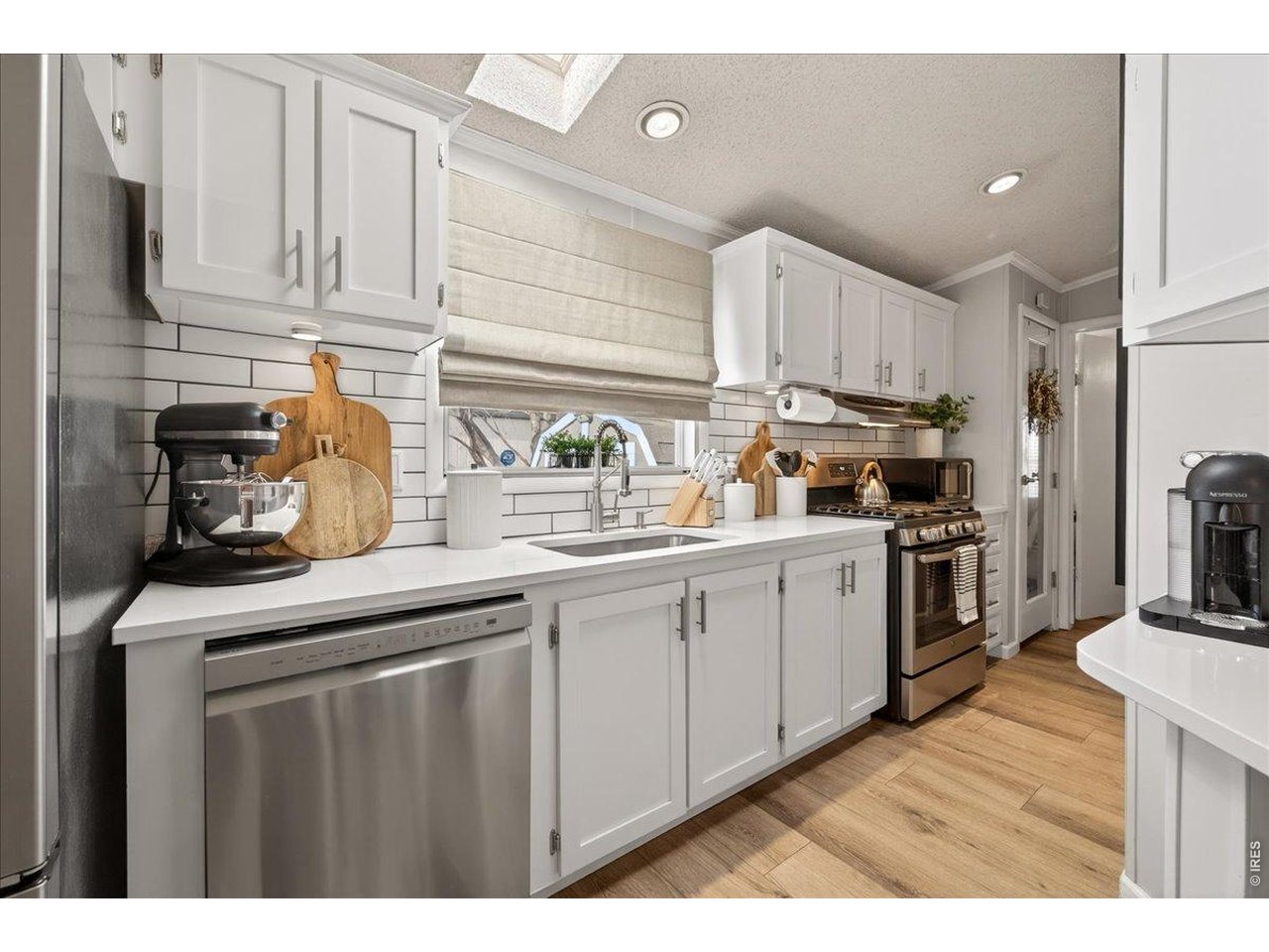 8410 Madison Way Denver, CO 80229 - Photo 8 of 40 Subway tile backsplash and modern finishes complete the clean, contemporary design.