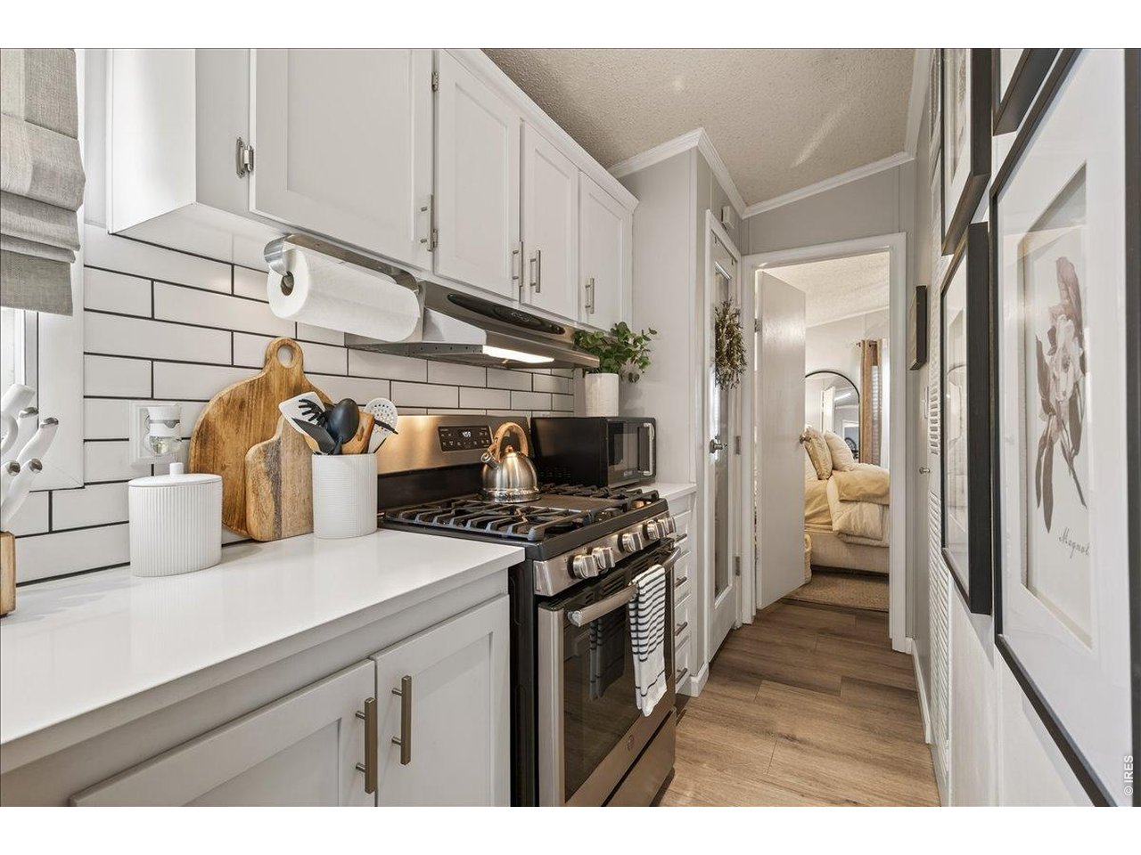 8410 Madison Way Denver, CO 80229 - Photo 9 of 40 Updated kitchen features crisp cabinetry, quartz surfaces, and modern stainless steel appliances.