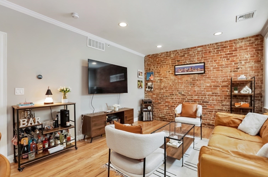 454 Hanover Street, Unit 4 Boston, MA 02113 - Photo 5 of 23 a living room with furniture and a flat screen tv