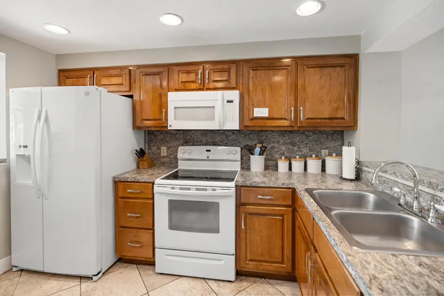 a kitchen with a stove a sink and a refrigerator