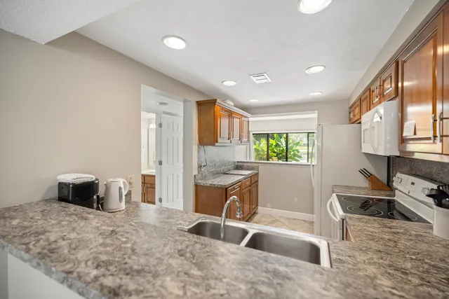 a kitchen with sink cabinets and stove