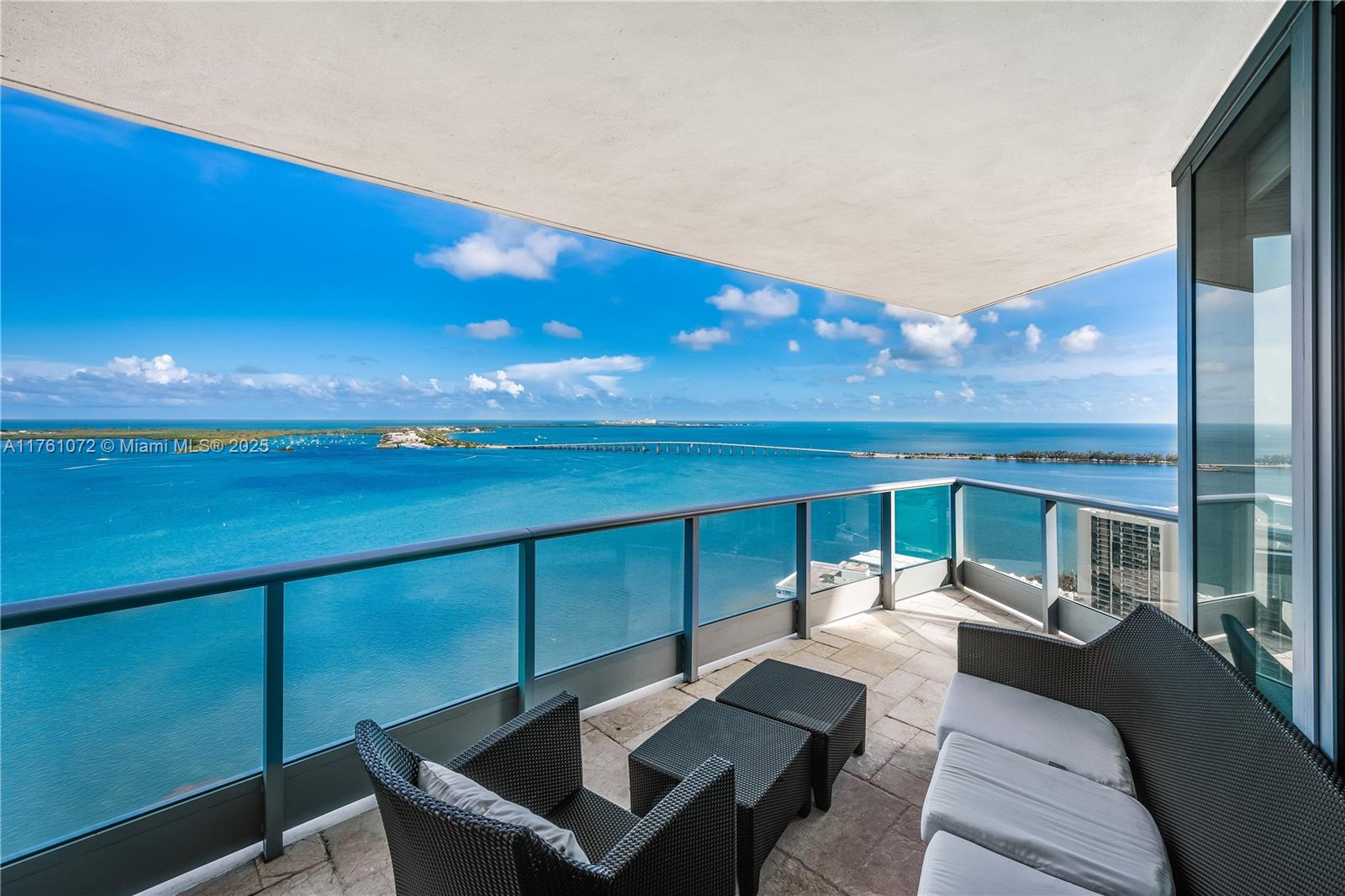 1331 Brickell Bay Drive, Unit 3311 Miami, FL 33131 - Photo 30 of 43 a view of a patio with dining table and chairs with wooden floor