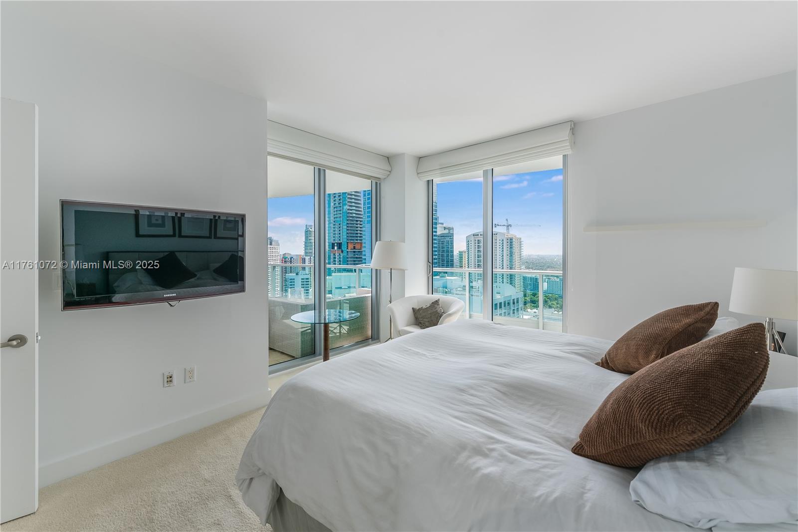 1331 Brickell Bay Drive, Unit 3311 Miami, FL 33131 - Photo 4 of 43 a bedroom with a large bed and a flat screen tv