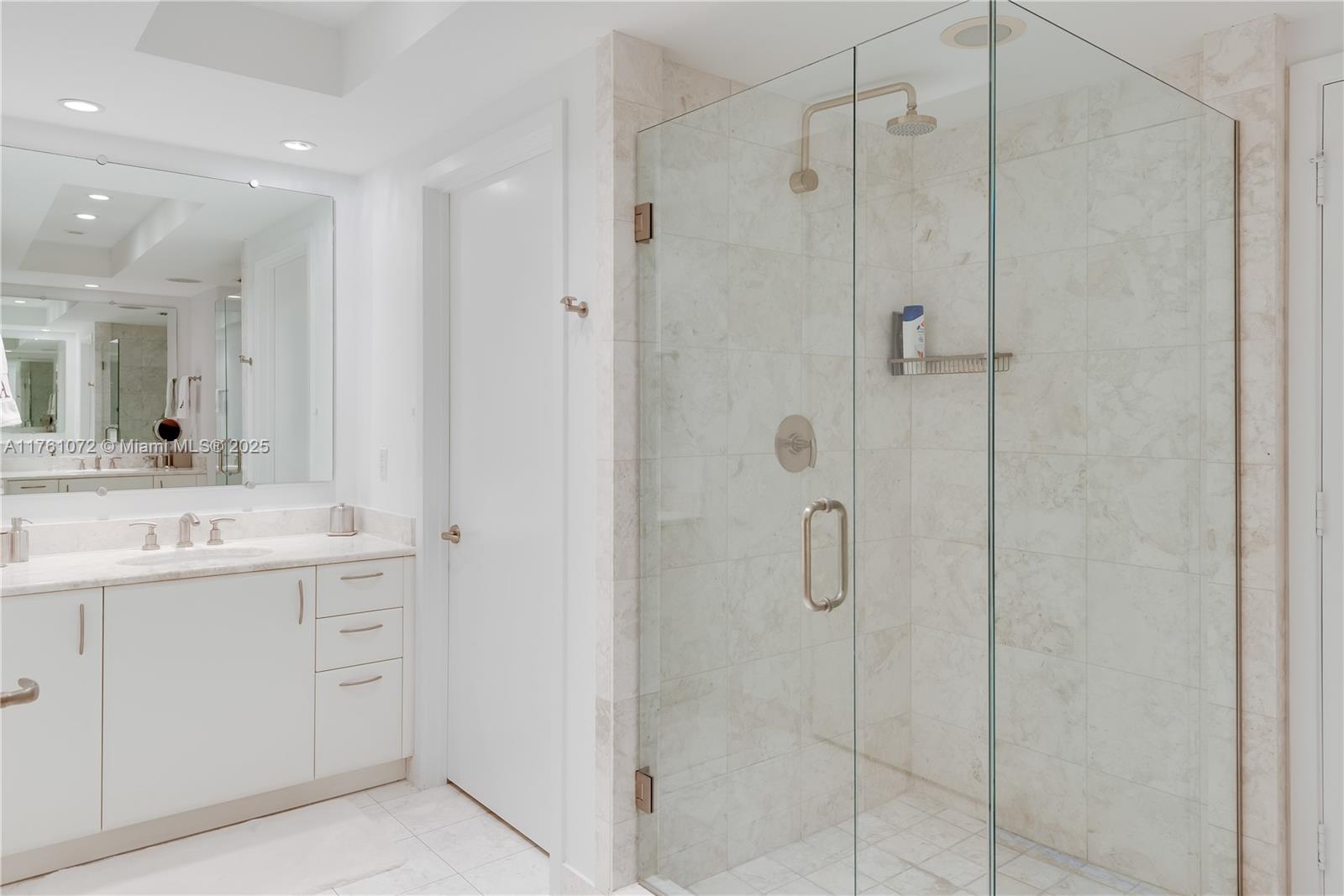 1331 Brickell Bay Drive, Unit 3311 Miami, FL 33131 - Photo 43 of 43 a bathroom with a shower sink and mirror