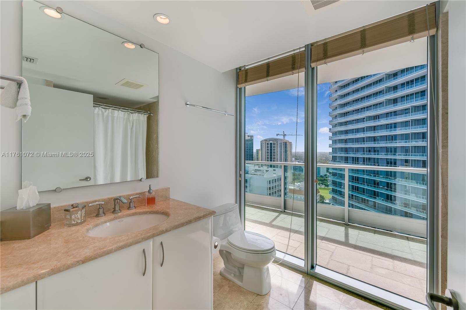 1331 Brickell Bay Drive, Unit 3311 Miami, FL 33131 - Photo 5 of 43 a bathroom with a granite countertop sink a toilet and shower