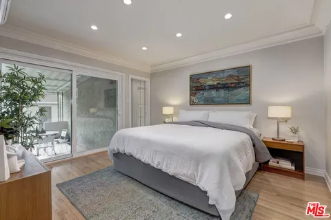 a bedroom with a large bed and a large window