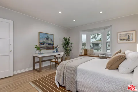 a bedroom with a bed and a table