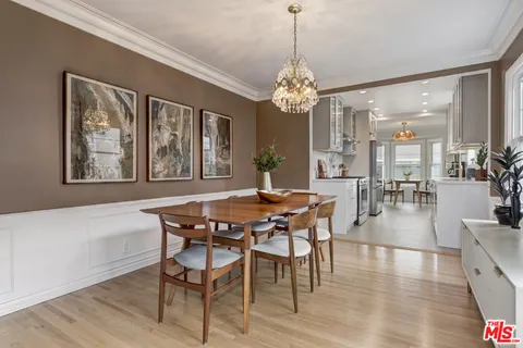 a view of a dining room with furniture wooden floor and chandelier